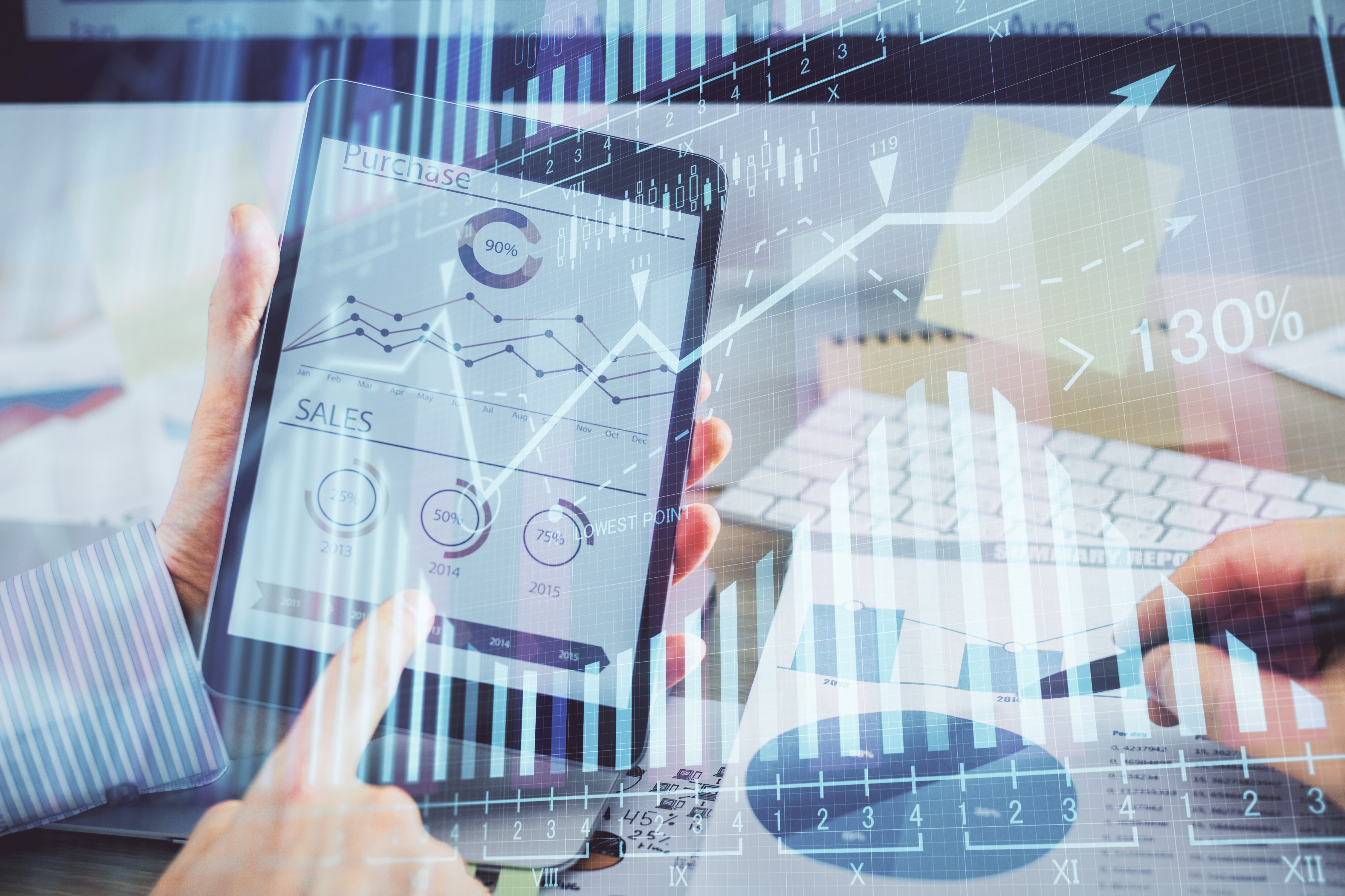 Procurement manager reviews procurement spend analysis data on tablet computer, overlaid with transparent bar graph.