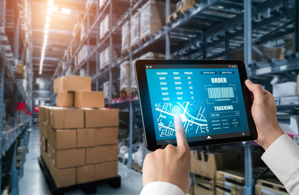 Procurement specialist uses tablet to check inventory data stored in the cloud.